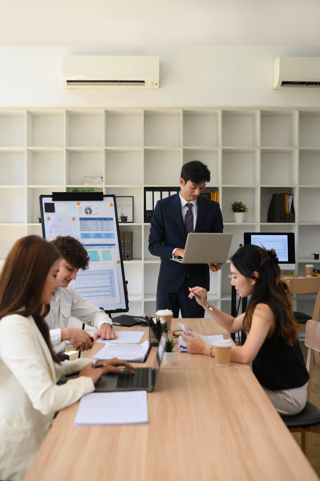 Diverse Business Team Collaborating During Office Presentation, Vertical image.